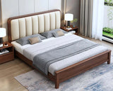 Wooden bed with upholstered headboard in a bedroom setting